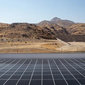 Rows of panels at a ground-mounted solar array in desert foothills