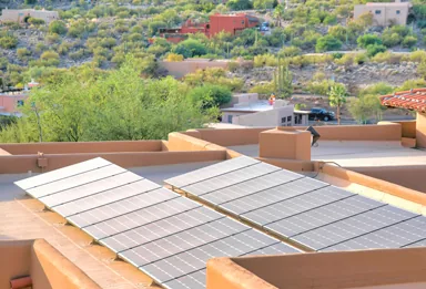 Solar panels on adobe rooftops in a desert neighborhood